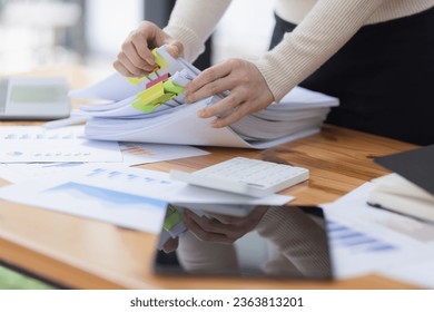Businesswoman hands working with document papers at work desk in office. - Shutterstock ID 2363813201