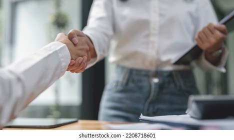 Businesswoman handshake and business people. Successful business concept. - Shutterstock ID 2208718601