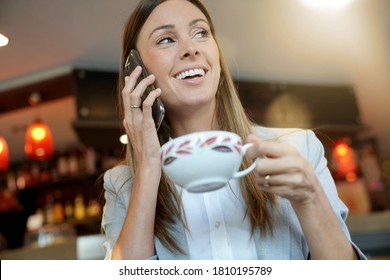 Businesswoman having breaksfast at train station cofffee shop