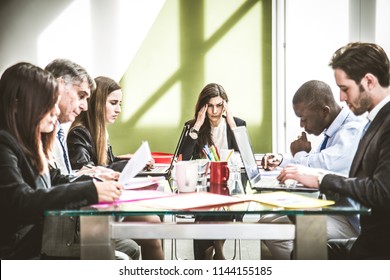 Businesswoman having headache during a business meeting - Depressed person with financial troubles