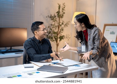 Businesswoman having a heated argument with a coworker who is smiling during a late night meeting at the office - Powered by Shutterstock