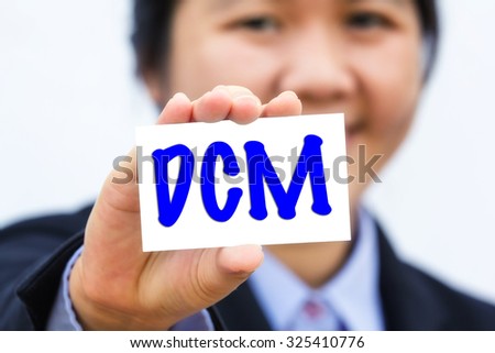 Businesswoman holding card with DCM message.