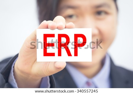 Businesswoman holding card with ERP message.