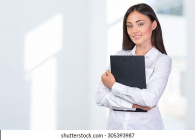 Businesswoman holding clipboard