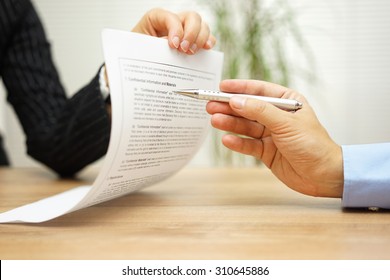 businesswoman holding legal document and  wants an explanation about article in contract