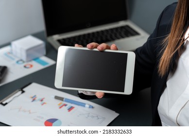 Businesswoman Holding Phone With Important Message With One Hand. Woman Having Celphone With Crutial Information. Executive Showing Critical Data On Tablet.