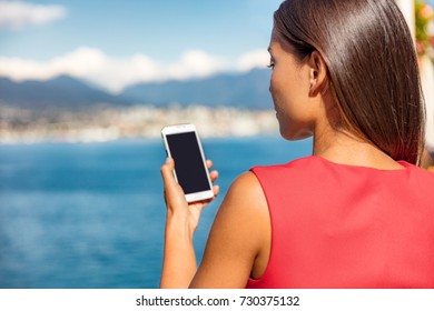 Businesswoman Holding Phone Looking At Screen Using Cellphone For Business. Businesspeople Lifestyle In City Outdoor Landscape, Vancouver, Canada.