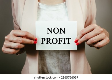 Businesswoman Holding Sheet Of Paper With Text Non Profit. Business, Charity, Financial Concept