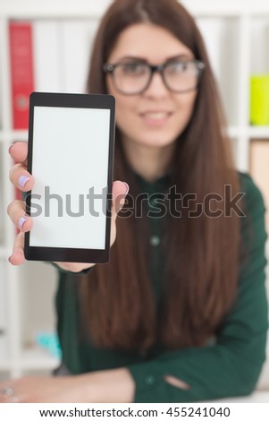 Businesswoman holding smartphone in hand, photo with depth of field