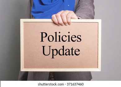 Businesswoman Holding A Softboard Written Policies Update