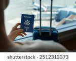 Businesswoman holding US passport and luggage while standing at airport.