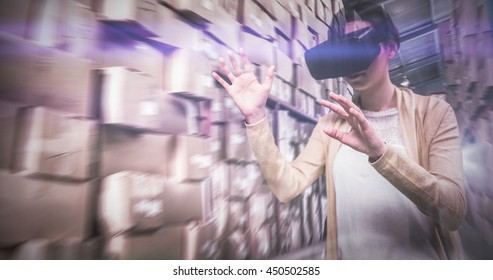 Businesswoman holding virtual glasses against forklift machine in warehouse - Powered by Shutterstock