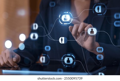 A businesswoman interacting with a digital interface displaying network icons. Futuristic design with blue tones. Concept of technology - Powered by Shutterstock