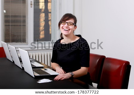 Image, Stock Photo Smiling businesswoman working at desk with laptop