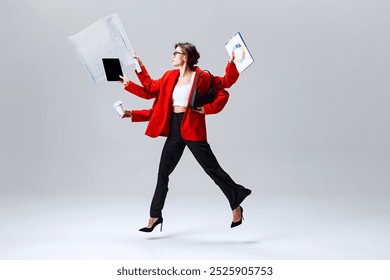 Businesswoman leaping through air, holding tablet, clipboard, and coffee, representing modern multitasking and fast-paced business life. Concept of speed, multitasking, modern businesswoman - Powered by Shutterstock