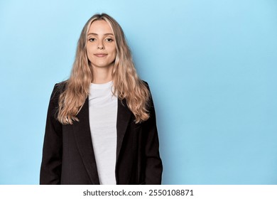 Businesswoman looking forward in blue studio - Powered by Shutterstock