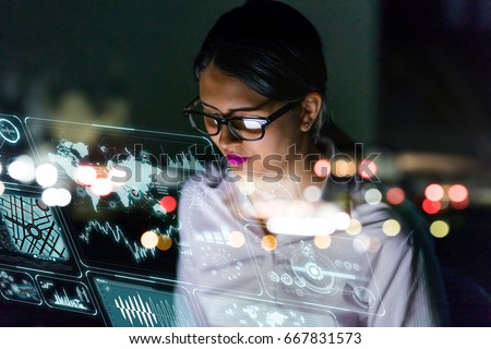 businesswoman looking at futuristic interface screen.