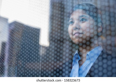 Businesswoman Looking Out Through Window, Reflection Of The City On The Glass