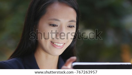 Businesswoman looking at tablet computer at night