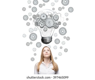 Businesswoman Looking Up, Bulb With Gears Painted Above. Front View. White Background. Concept Of New Idea.