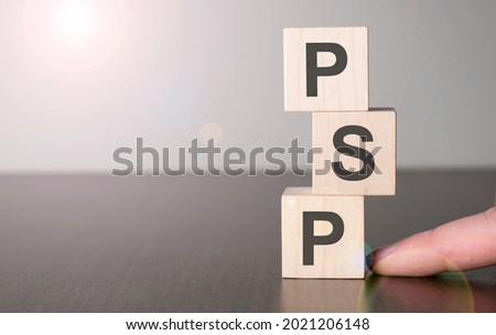 Businesswoman made word psp with wood building blocks.