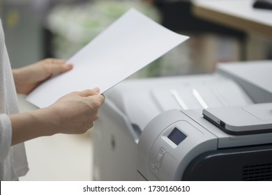 Businesswoman Making Copies With Copy Machine