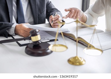 Businesswoman And Male Lawyer Or Judge Consult And Conference Having Team Meeting With Client At Law Firm In Office, Law And Legal Services Concept.