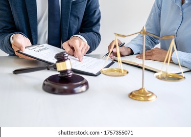 Businesswoman And Male Lawyer Or Judge Consult And Conference Having Team Meeting With Client At Law Firm In Office, Law And Legal Services Concept.