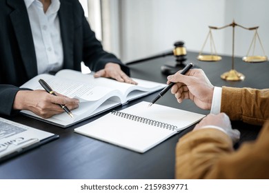 Businesswoman And Male Lawyer Or Judge Consult And Conference Having Team Meeting With Client At Law Firm In Office, Law And Legal Services Concept.