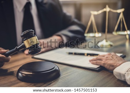 Businesswoman and Male lawyer or judge consult having team meeting with client, Law and Legal services concept.