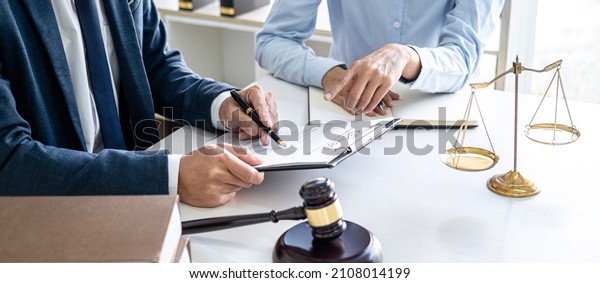Businesswoman and Male lawyer or judge consult\
and conference having team meeting with client at law firm in\
office, Law and Legal services\
concept.