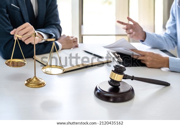 Businesswoman and Male lawyer or judge consult\
and conference having team meeting with client at law firm in\
office, Law and Legal services\
concept.