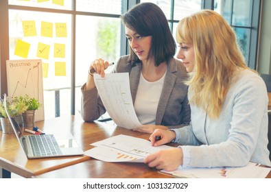 Businesswoman Management Working On Financial Dashboard With Diversity Data On Paperwork In Hands And Sticky Note Paper. Work Collaboration, Discussion And Talking About Forecast, Revenue In Office. 
