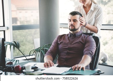 Businesswoman massaging shoulders to colleague at office. Office massage.
