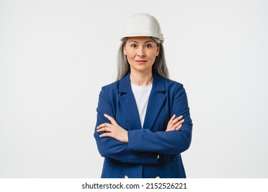 Businesswoman mature female construction worker, engineer, architect in formal suit looking at camera in protective hard hat isolated in white background. Real estate agent - Powered by Shutterstock