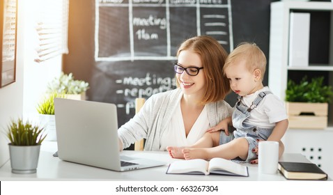 Businesswoman Mother  Woman With A Toddler Working At The Computer
