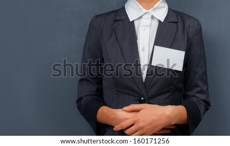 Businesswoman with a name tag on the chest, space for text