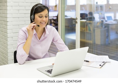 Businesswoman In The Office On The Phone With Headset, Skype