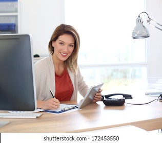 Businesswoman in office working with tablet