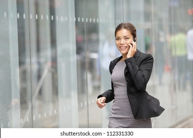 Businesswoman On Cellphone Running While Talking On Smart Phone. Happy Smiling Mixed Race Asian / Caucasian Business Woman Busy. Image From Manhattan, New York City.