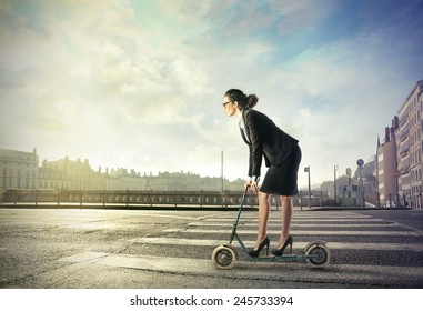 Businesswoman On A Push Scooter 