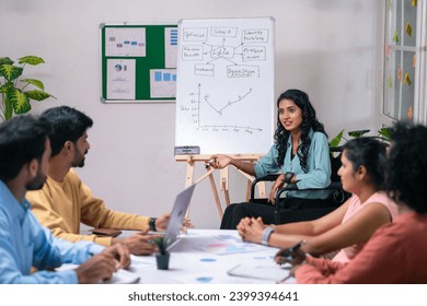 Businesswoman on wheelchair explaining from white board during team meeting at office - concept of empowerment, corporate planning and inspiration or motivation. - Powered by Shutterstock