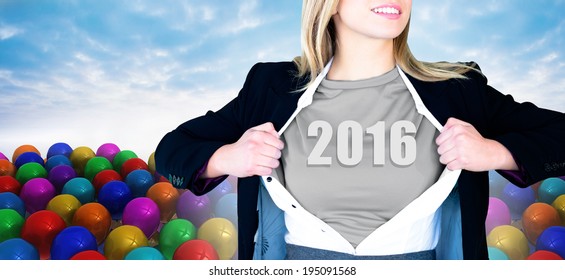 Businesswoman opening shirt in superhero style against many colourful balloons against sky