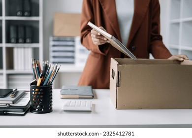 Businesswoman packing up in office, job promotion concept. - Powered by Shutterstock