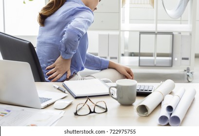 Businesswoman with pain in back