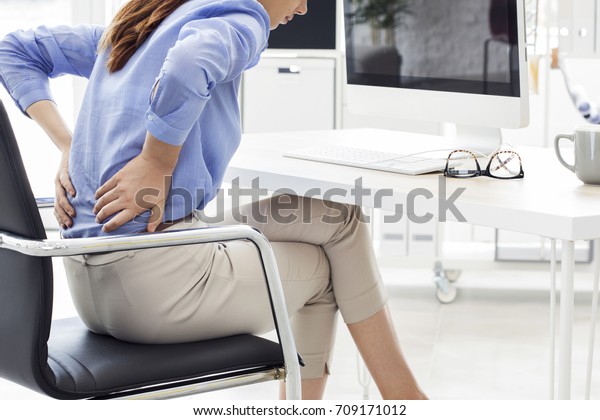 Businesswoman with pain in back\
