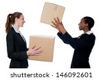 Businesswoman passing packed cartons