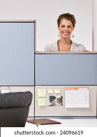 Businesswoman Peering Over Cubicle Wall