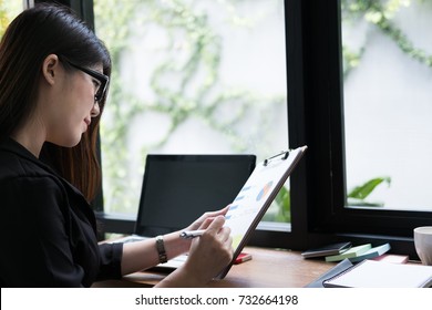 businesswoman plan new business project at workplace. woman analyze market data report at office. Young finance analyst work with financial graph & chart diagram document. - Shutterstock ID 732664198