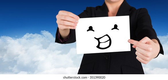 Businesswoman pointing to card against bright blue sky over clouds